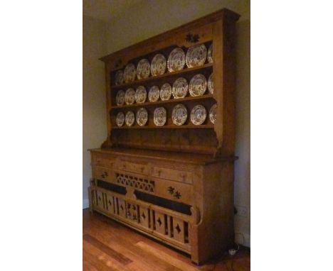 A 20th Century pine dresser and rack, the base with three drawers and a removable dog gate