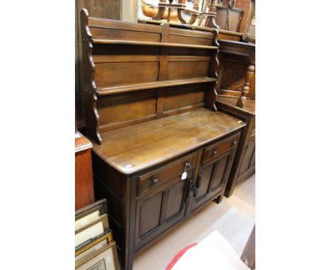 A late 20th Century oak dresser and rack, probably by Ercol