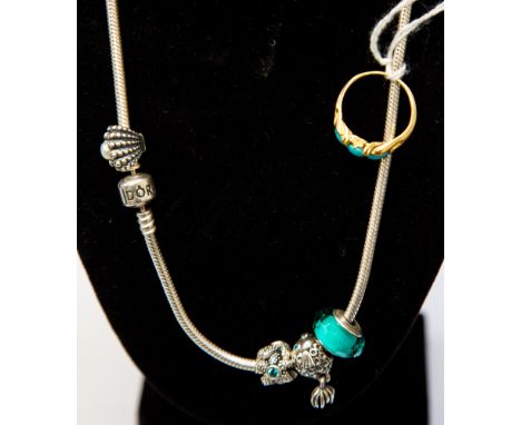 A yellow gold ring, probably 18ct gold, set with three oval  turquoise, together with a Pandora silver necklace with faceted 