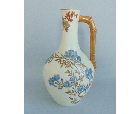 A Royal Worcester  Ewer  of 'The Aesthetic Movement' Style.  Decorated with Floral Sprays on an Ivory Ground, with a Bamboo H