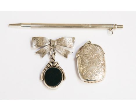 A silver vesta case, Chester 1905, J & R Griffin with chased design and monogram, together with a silver fob brooch with bow 