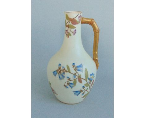 A Royal Worcester Ewer of 'The Aesthetic Movement' Style. Decorated with Flower sprays on an Ivory Ground, With a Bamboo Hand