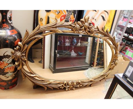 A large contemporary gilded wall mirror, in the Rococo manner,
