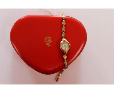 A ladies vintage 9ct gold Tudor bracelet watch,with round dial set in a fancy case, diameter  approx  14mm wide, original fan