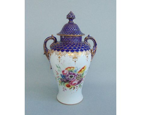 A Royal Worcester  Twin Handled Vase & Cover.Decorated with Floral spays  on a white ground with  an elaborate Gilded border 