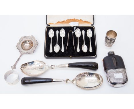 A cased set of Art Deco silver teaspoons, with sugar tongs, London 1933/4; together with a tea strainer marked 900, a set of 