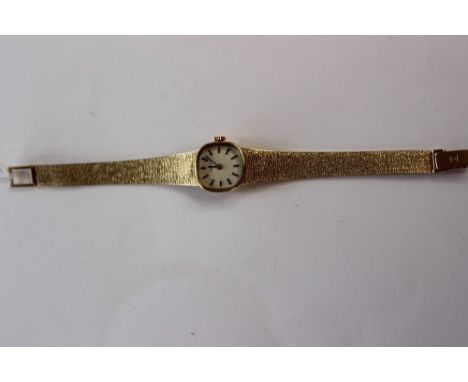 A 9ct ladies Tissot watch with cushion shape face, on a bark effect strap, dial size approx 15mm, total gross weight approx 2