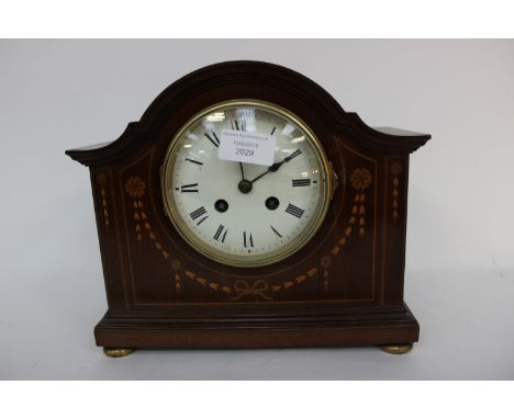 An Edwardian mahogany and inlaid mantle clock 