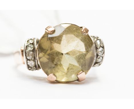 A rose metal and white metal ring, unmarked but probably 9ct, set with a round citrine, approx size 13ct, with five rose cut 