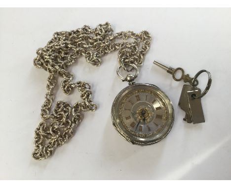 A silver hunter, Edinburgh, engine turned, with gold details, case diameter approx 38mm,  white metal chain (key) with a comb