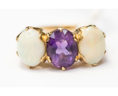  An opal and amethyst ring, set with two oval opals either side of an oval amethyst, the stones all measuring approx 9 x 7mm,