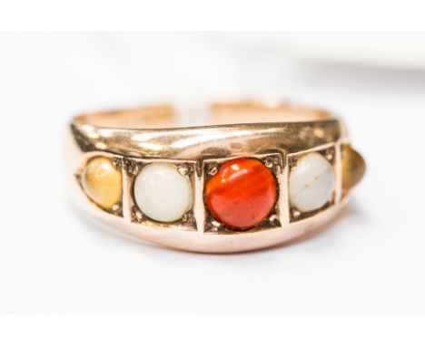 A 19th Century rose gold 9ct ring, set with a central cabochon carnelian, with moonstone and citrine stones either side, size