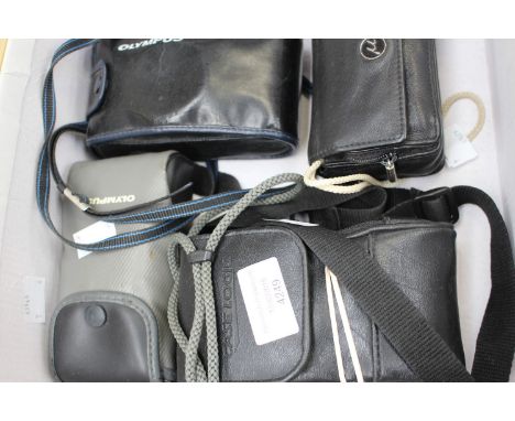Three cased Olympus cameras and a cased Nikon camera (4)