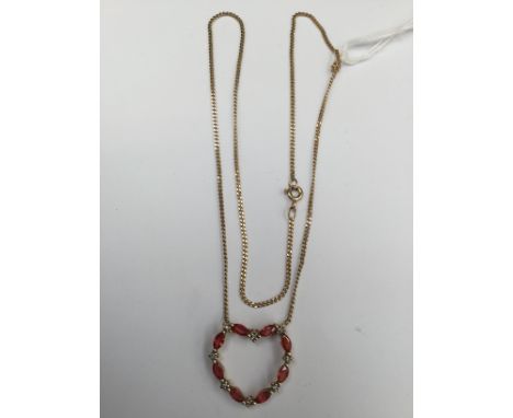A 9ct gold heart shaped pendant set with alternate possibly orange garnets and white stones; together with a 9ct gold chain 