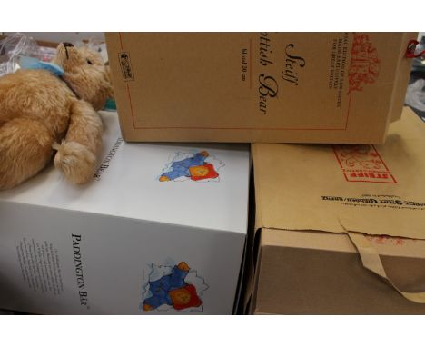 Four modern Steiff bears: Paddington, Blonde (approx 30cm), Champagne (approx 40cm), all boxed, together with a plush bear wi