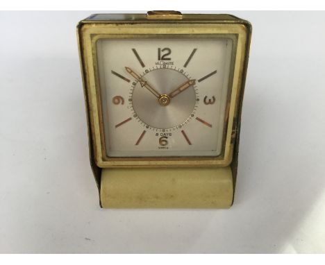 A Le Coultre 8 day folding travel alarm clock, 1950s, working, yellow cream enamel, case size approx 55mm x 80mm