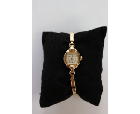  A circa 1950's yellow metal cased Bulova watch, on a gilt expander strap, with original box 