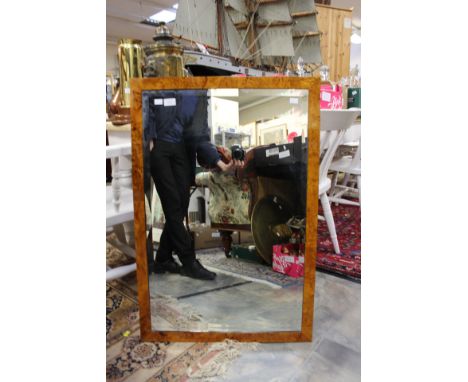 A bevelled edged mirror in maple frame (1)