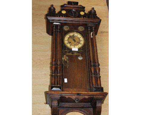 A 19th Century Vienna eight wall clock, the glazed door opening to reveal chapter ring, Roman numerals, the door with applied