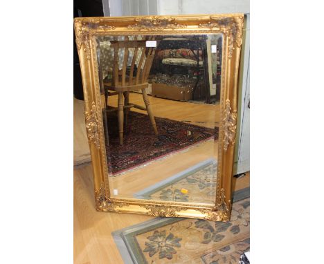 A gilt framed rectangular mirror