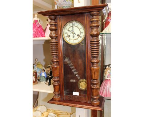 A late 19th Century Vienna wall clock, having an eight day movement, cream chapter ring, with black Roman numerals, the door 