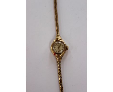 9ct gold ladies longines wristwatch, with cream dial, batons and numbers, on a snake link chain strap, total gross weight app