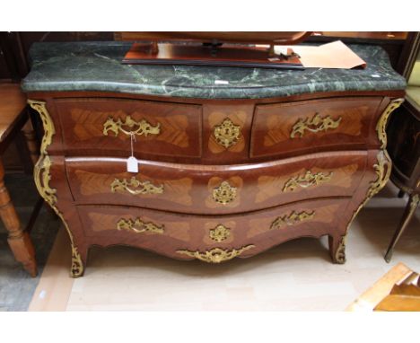 A Louis XV style 'Bombe' kingwood commode, of serpentine form, having a green marble top, applied gilt metal mounts, fitted w