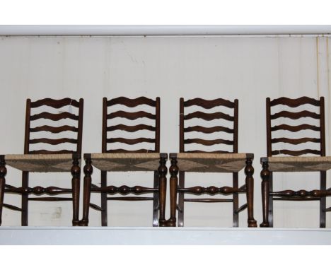 A set of four early 20th Century oak ladder back chairs, each fitted with rush seats (4) 