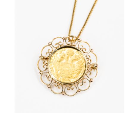 An Austrian gold coin dated 1915 in a 9ct gold pendant/brooch mount on a box chain, length 18'' with a combined total gross w