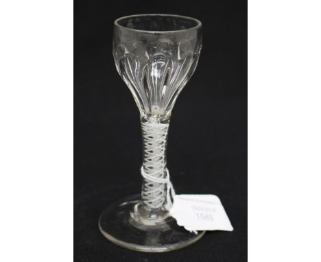 An 18th Century opaque twist wine glass, the ogee bowl with moulded fluting on a double strand and multi spiral corkscrew ste