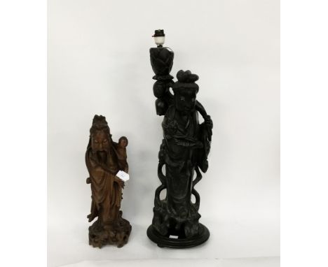 A Chinese hardwood carved lamp stand in the form of a Chinese man, with wire inlay; together with a carved hardwood Chinese m