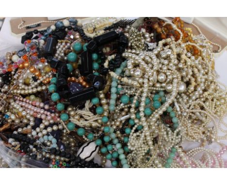 A collection of costume jewellery to include plastic, glass, resin and faux pearl beads, an agate bead strand, chain and bead