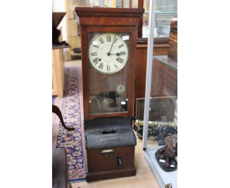 A National Time Recorder Ho Ltd clocking in clock, St. Mary Gray, Kent, having Roman numerals, oak case