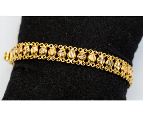 A Saudi Arabian yellow metal link bracelet, formed of diamond cut circles with ring connectors, approx 13 grams (probably 22c