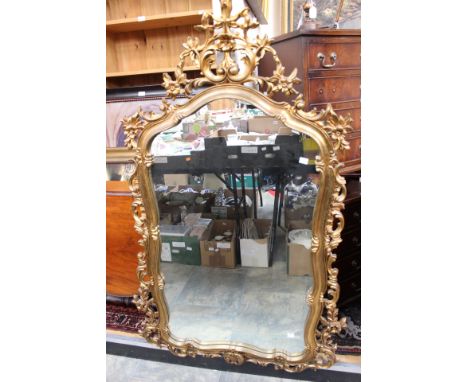 A large contemporary gilt framed wall mirror, in the Rococo style