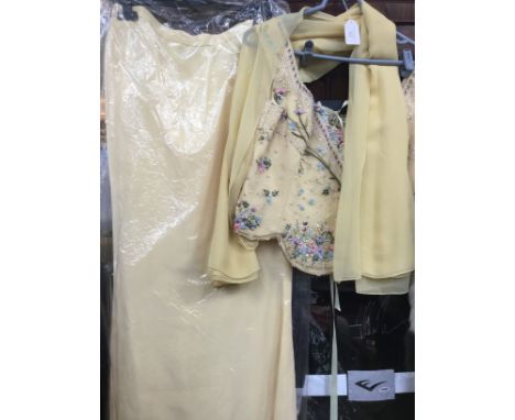 A lemon jacket skirt and scarf made by Bellville Sassoon, the bodice is heavily embellished in beadwork in pearls sequins etc