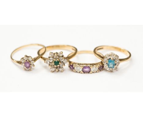 Four 9ct gold dress rings, set with white stones, amethyst, emerald and blue topaz, combined total gross weight approx 7.7gms