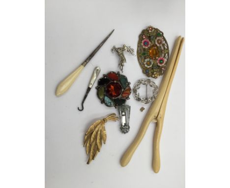 An ivory glove stretcher, button hook - mother of pearl handle, stitch holder - bone handle; together with Edwardian brooch, 