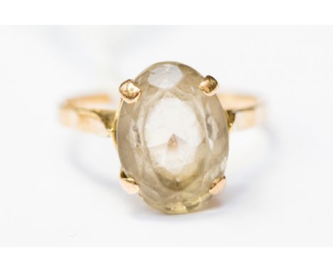 A topaz and  yellow metal ring, probably 9ct gold, comprising an oval claw set topaz, size R, with a total gross weight of ap