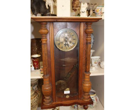 A late 19th Century Vienna wall clock, having an eight day movement, the door enclosing face with chapter dial, complete with