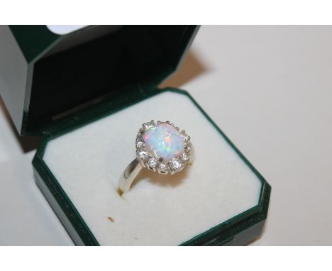 A Sterling silver, opal and Cubic Zirconia Halo ring, ring size L/M