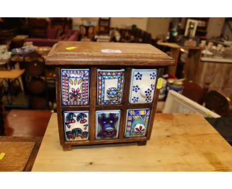 A small wooden and ceramic nest of spice drawers 