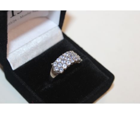A diamant&eacute; and purple stone set ring