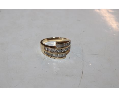 A yellow metal ring marked 14K set with round cut and baguette diamonds, ring size O, 8.5gms total weight 