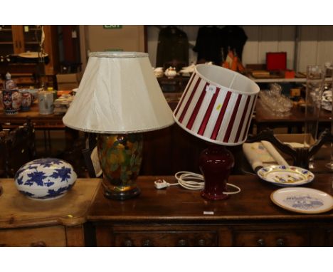 A Sang de Boeuf table lamp and shade and a floral and foliate decorated table lamp with shade 