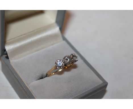 An 18ct gold and diamond three stone ring, 3.5gms total weight, ring size M
