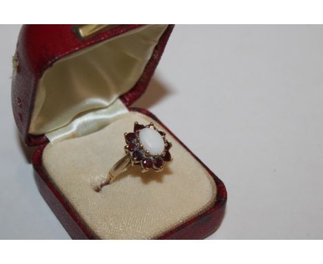 A vintage Hallmarked 9ct gold opal and garnet halo ring, ring size K, 2.8gms 