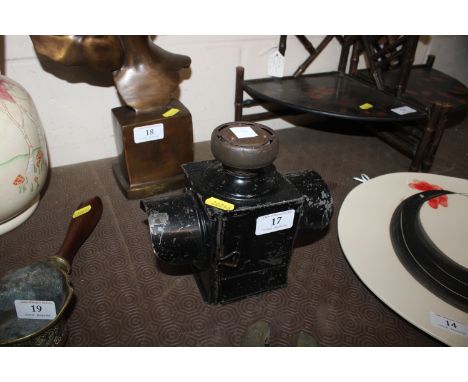 A vintage black painted tin lamp