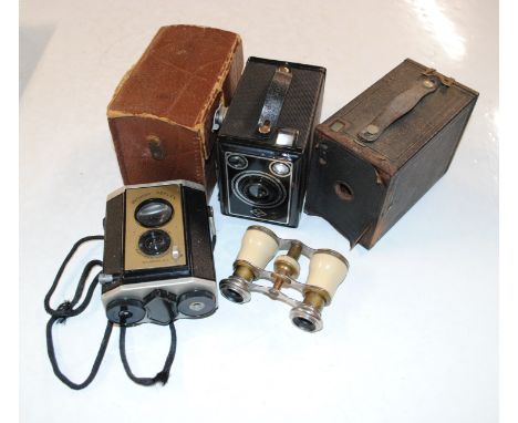 A box containing an Agfa box camera in leather case, a Brownie No.2 model F camera, a Brownie Reflex camera, and a pair of op