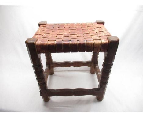 Robert Mouseman Thompson - Oak stool with nailed plaited leather top on segmented octagonal legs joined by waived stretchers,